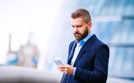 hipster-manager-with-smart-phone-london-city-hall-PBBAF8T